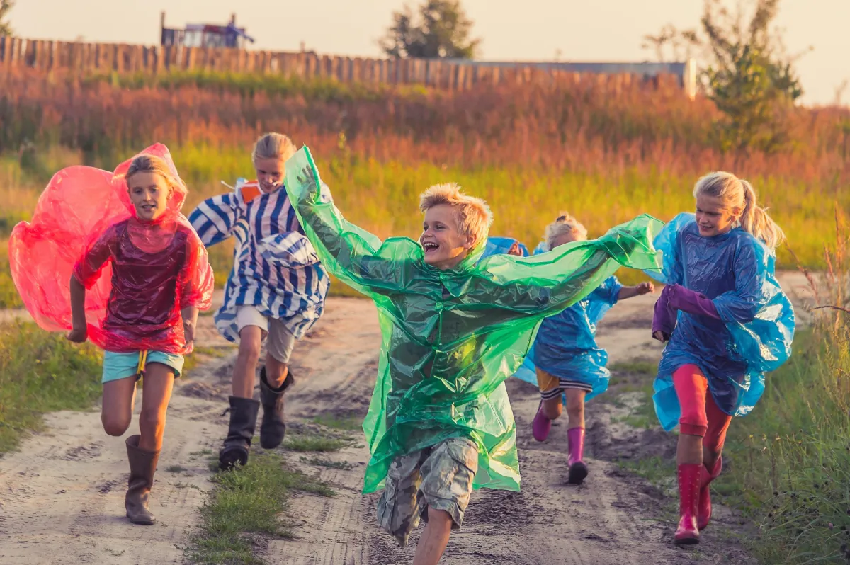 Children playing freely in an open field, symbolising the importance of parental support in giving children a safe, serene and emotionally healthy life
